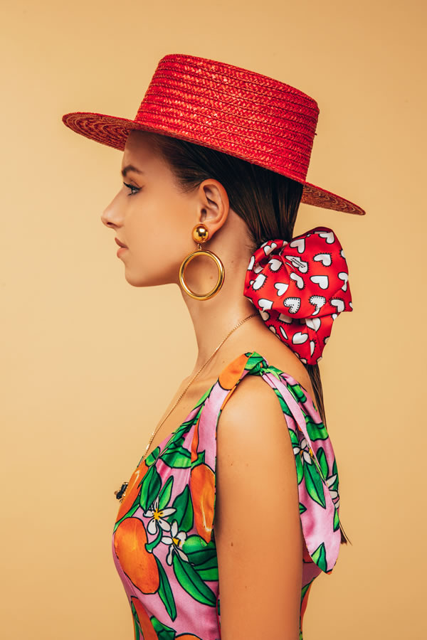 girl with red hearts oversize scrunchy and "baciami ancora" hat